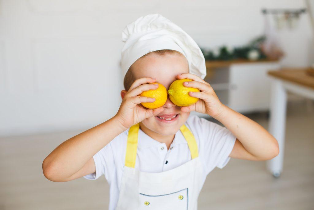 Child having fun dressed in a chefs uniform inspired by Mica Ven on Celebrity MasterChef 2023