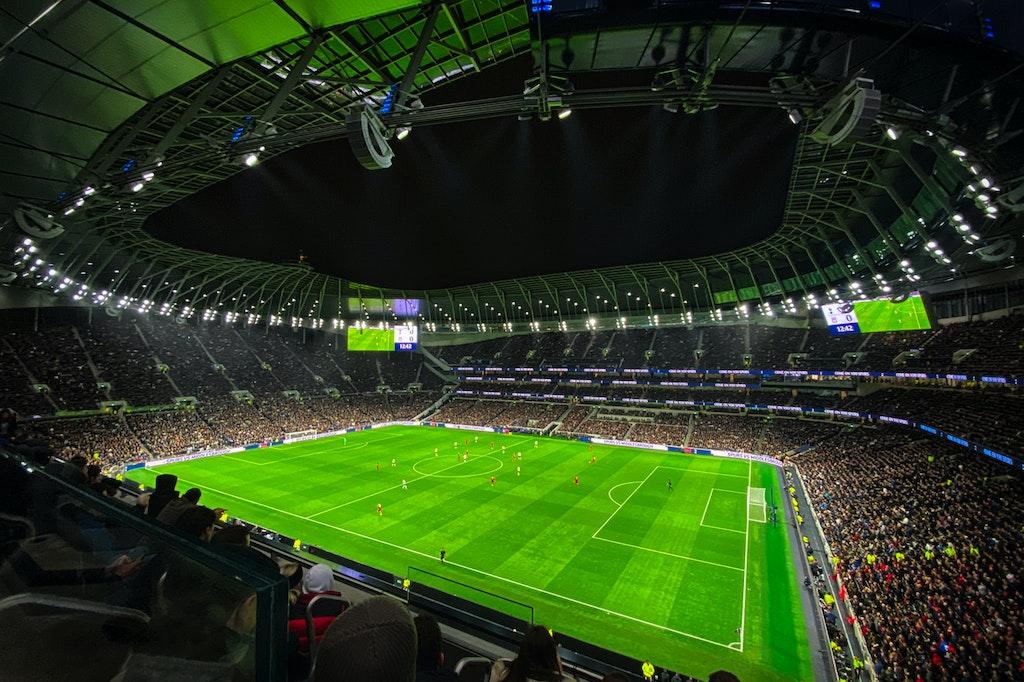 Image of people sitting in a football stadium at a premier league match